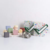 waterless personal care and cleaning bars next to the Good Design Award trophies